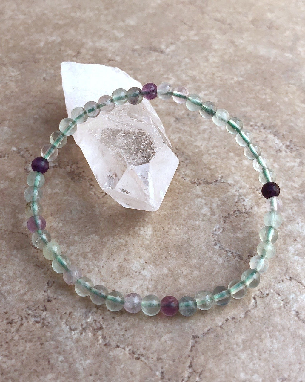 Men's Fluorite 4mm Beaded Gemstone Bracelet on a crystal