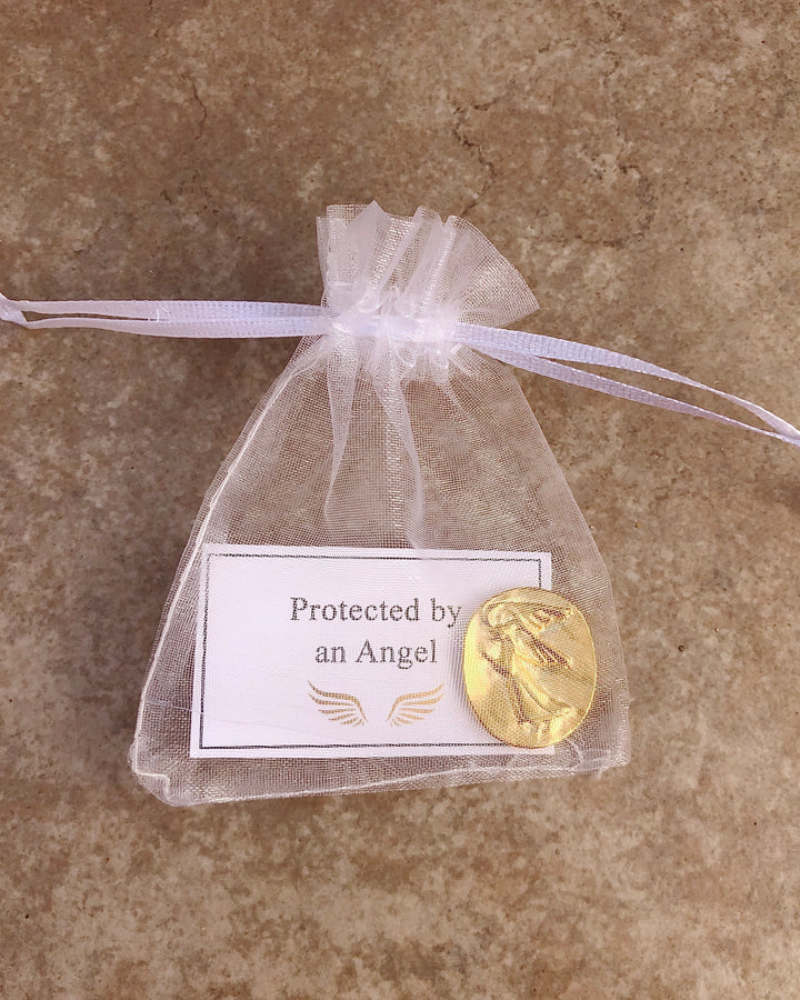 Gold pocket angel in white organza pouch with protected by an angel card