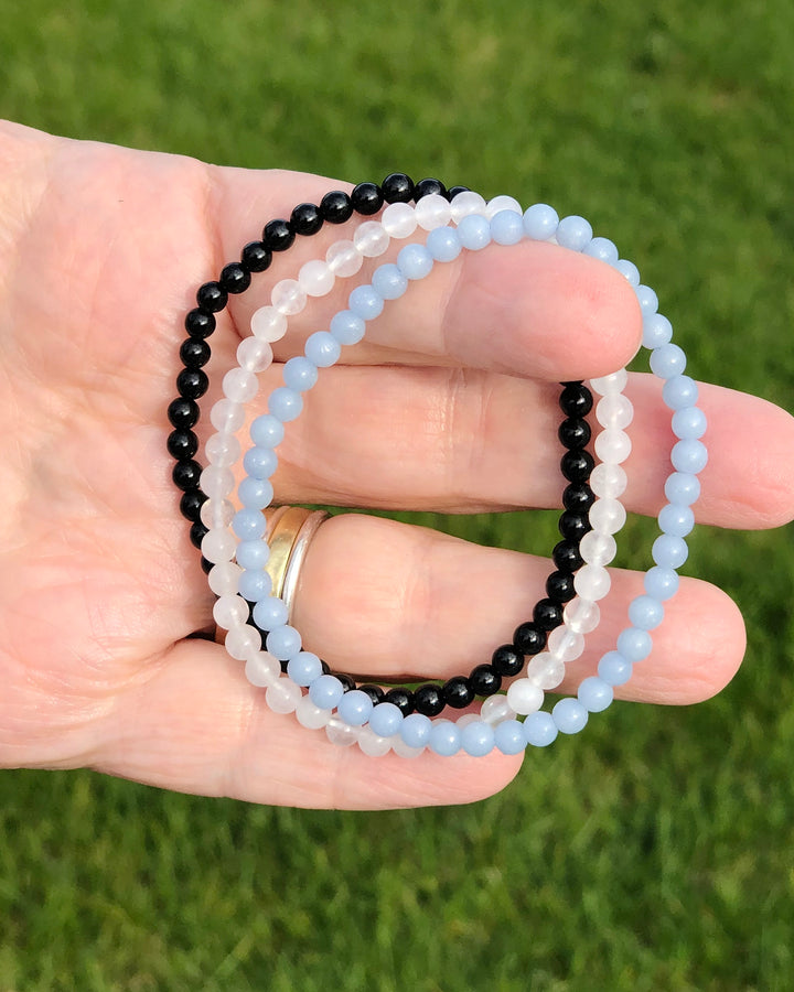 Aquamarine, Snow Quartz and Black Agate in a hand