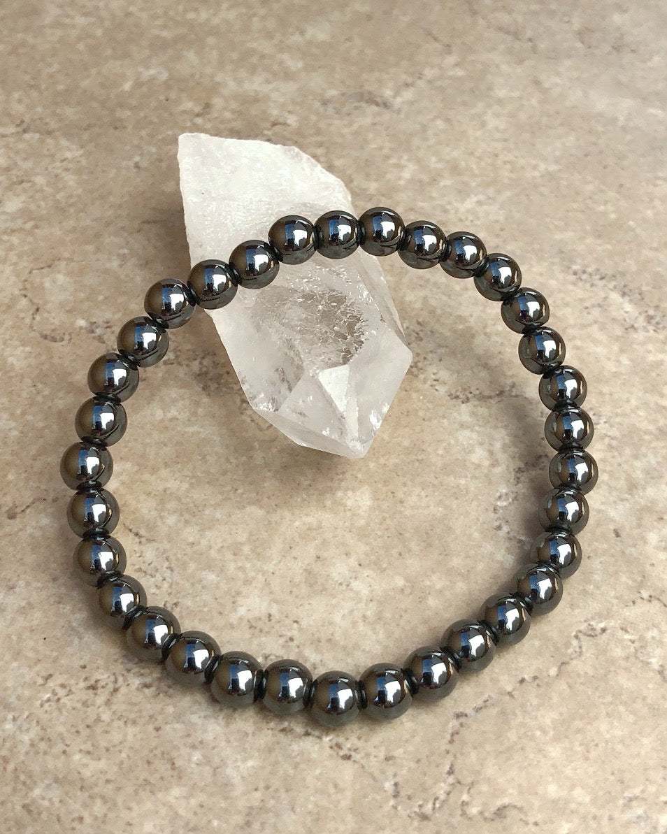 Hematite 6mm Beaded Gemstone Bracelet on a crystal.