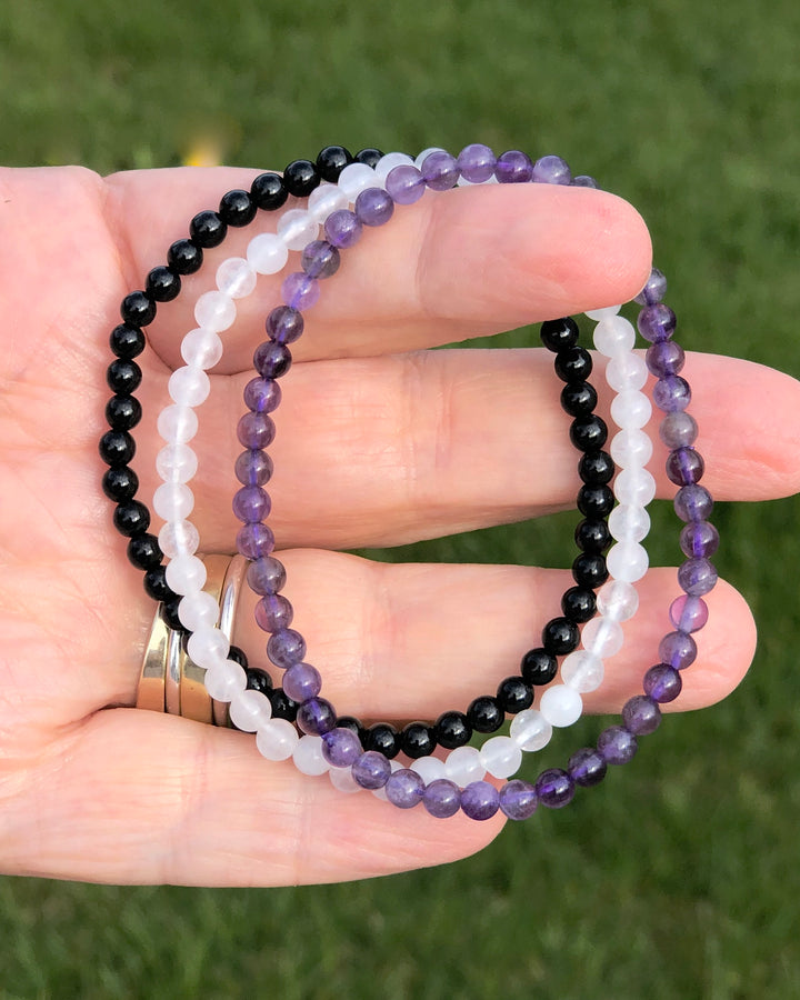 Amethyst, Snow Quartz and Black Agate in a hand