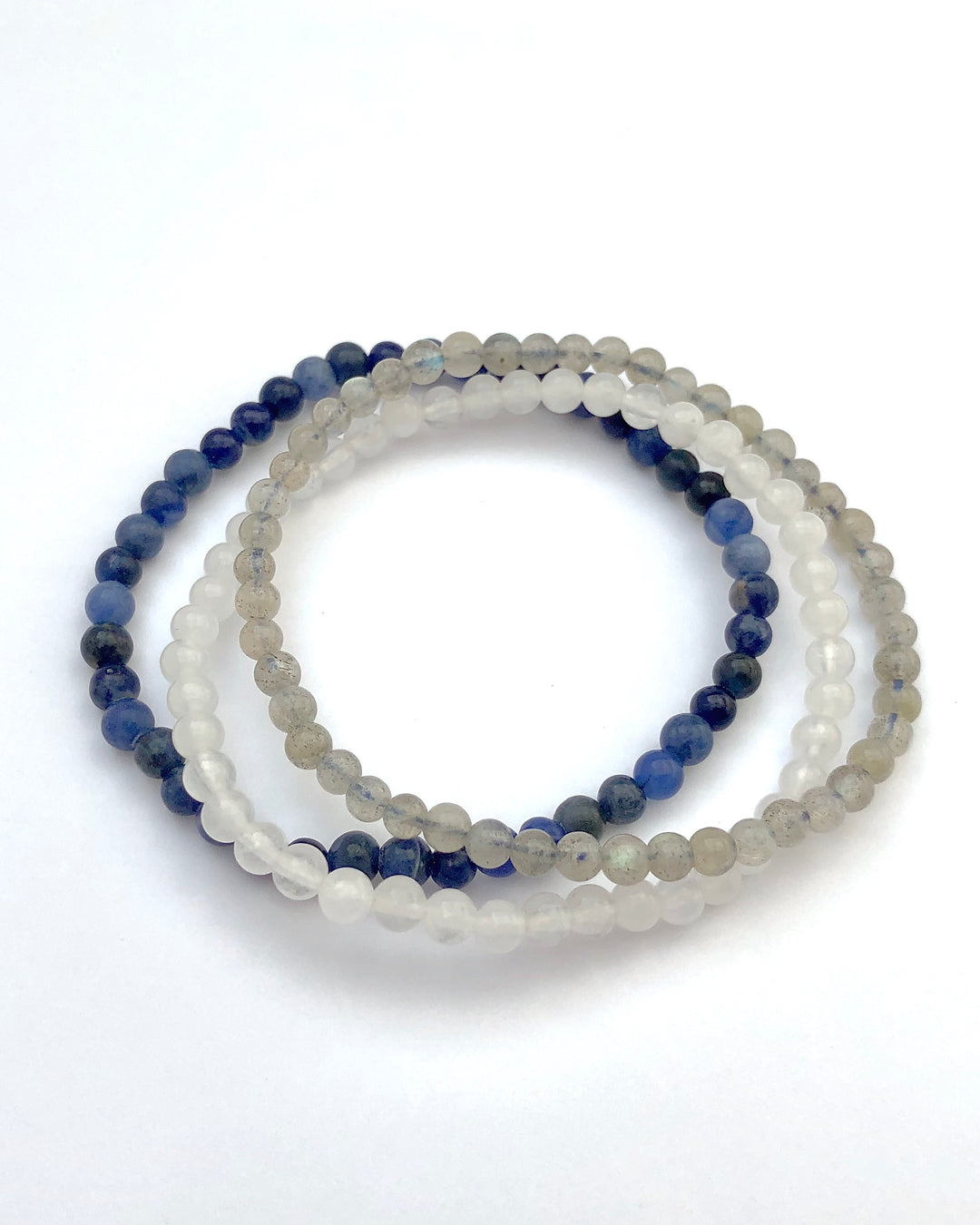  Labradorite, Snow Quartz and Lapis Lazuli Bracelets on a White Background