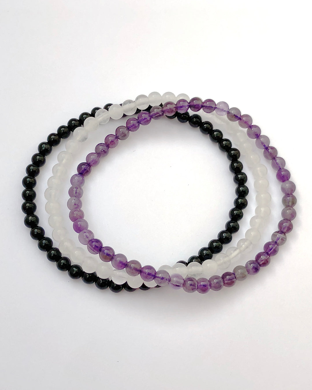 Inner Peace 4mm Beaded Gemstone Bracelet Set with Amethyst, Snow Quartz and Black Agate on a white background