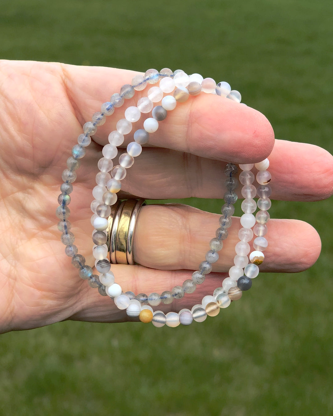Inner Strength 4mm Beaded Gemstone Bracelet Set with Botswana Agate, Snow Quartz and Labradorite in a hand