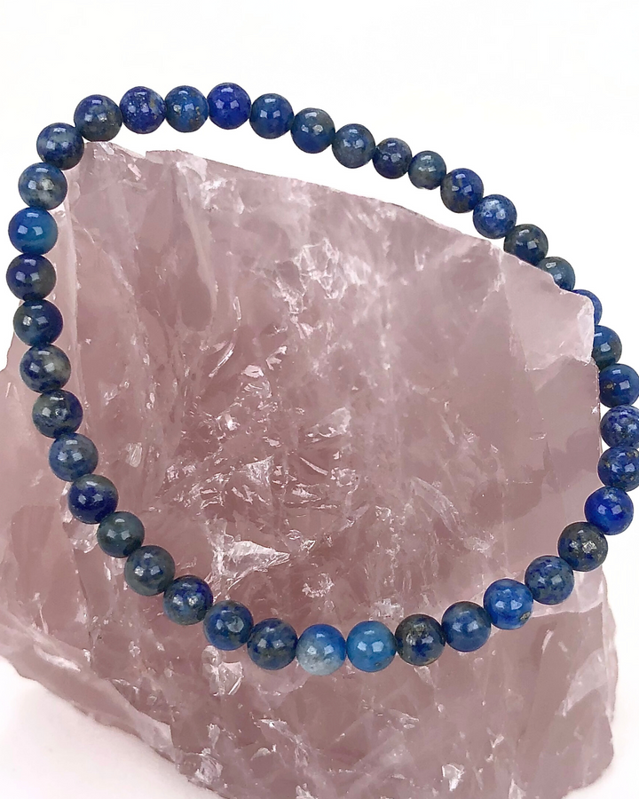 Lapis Lazuli 4mm Beaded Gemstone Bracelet  on a rose quartz stone