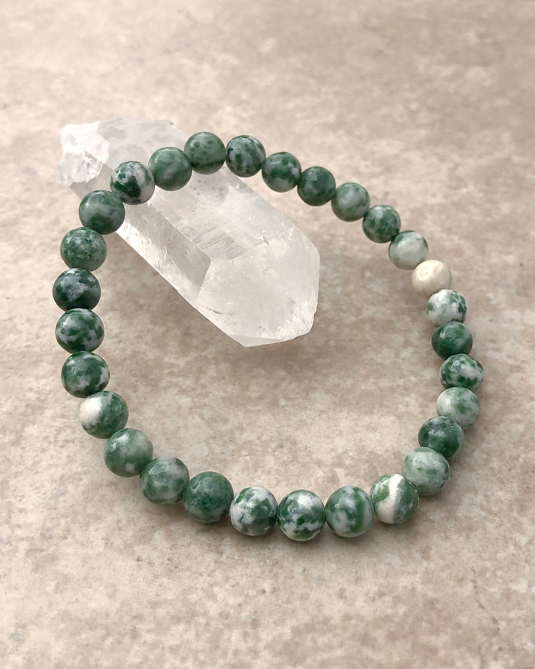 Natural Green Jade 6mm Beaded Gemstone Bracelet on a crystal.