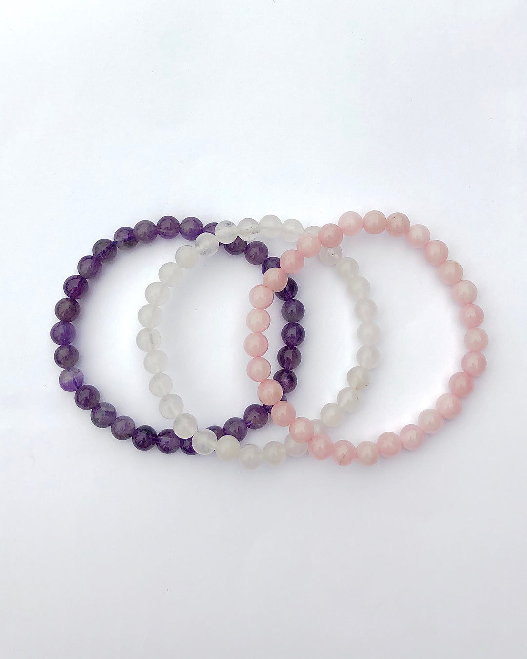 Rose Quartz, Snow Quartz and Amethyst 6mm Beaded Gemstone Bracelet Set on a white background.