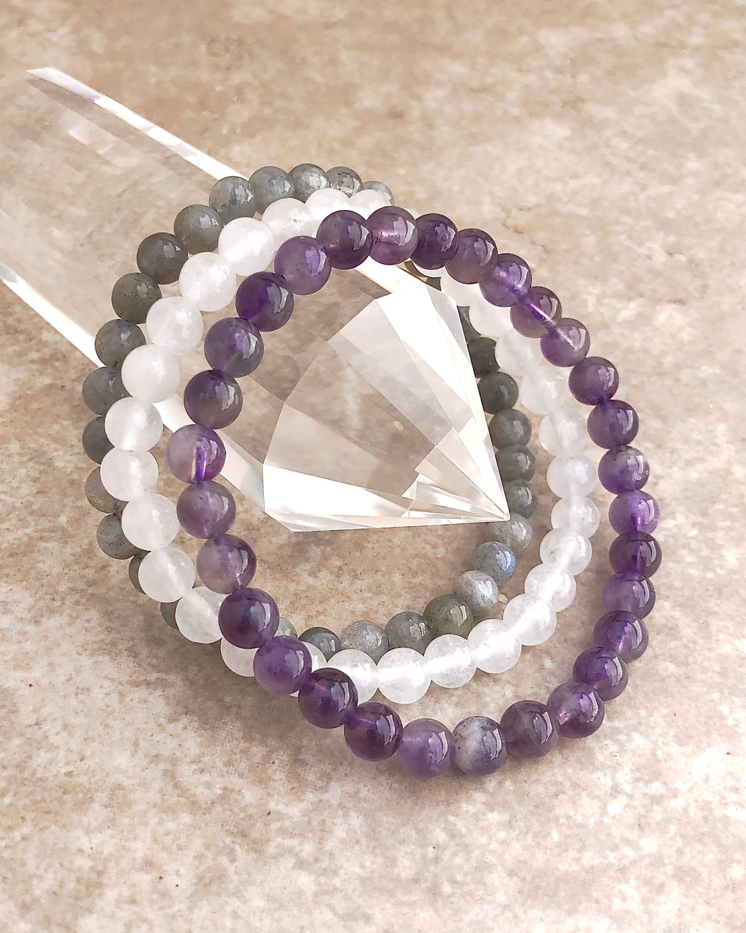 Amethyst, Snow Quartz and Labradorite 6mm beaded Gemstone Bracelet Set for Peaceful Transformation on a crystal.