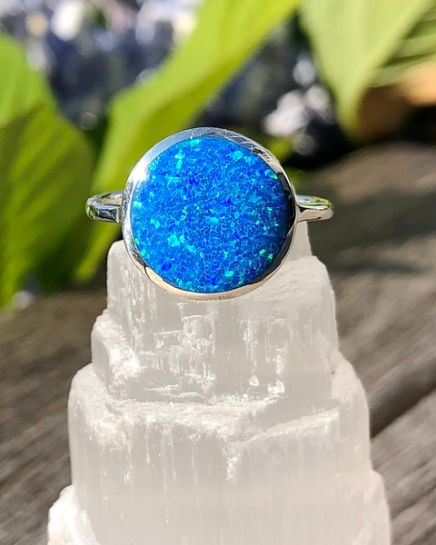 Sterling Silver Round Lab Opal Ring displayed on selenite