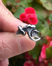 Sterling Silver Chanterelle mushroom ring being held between two fingers