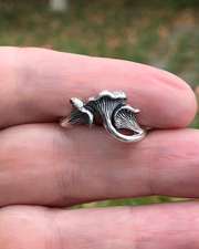 Sterling Silver Chanterelle mushroom ring held between two fingers inside hand