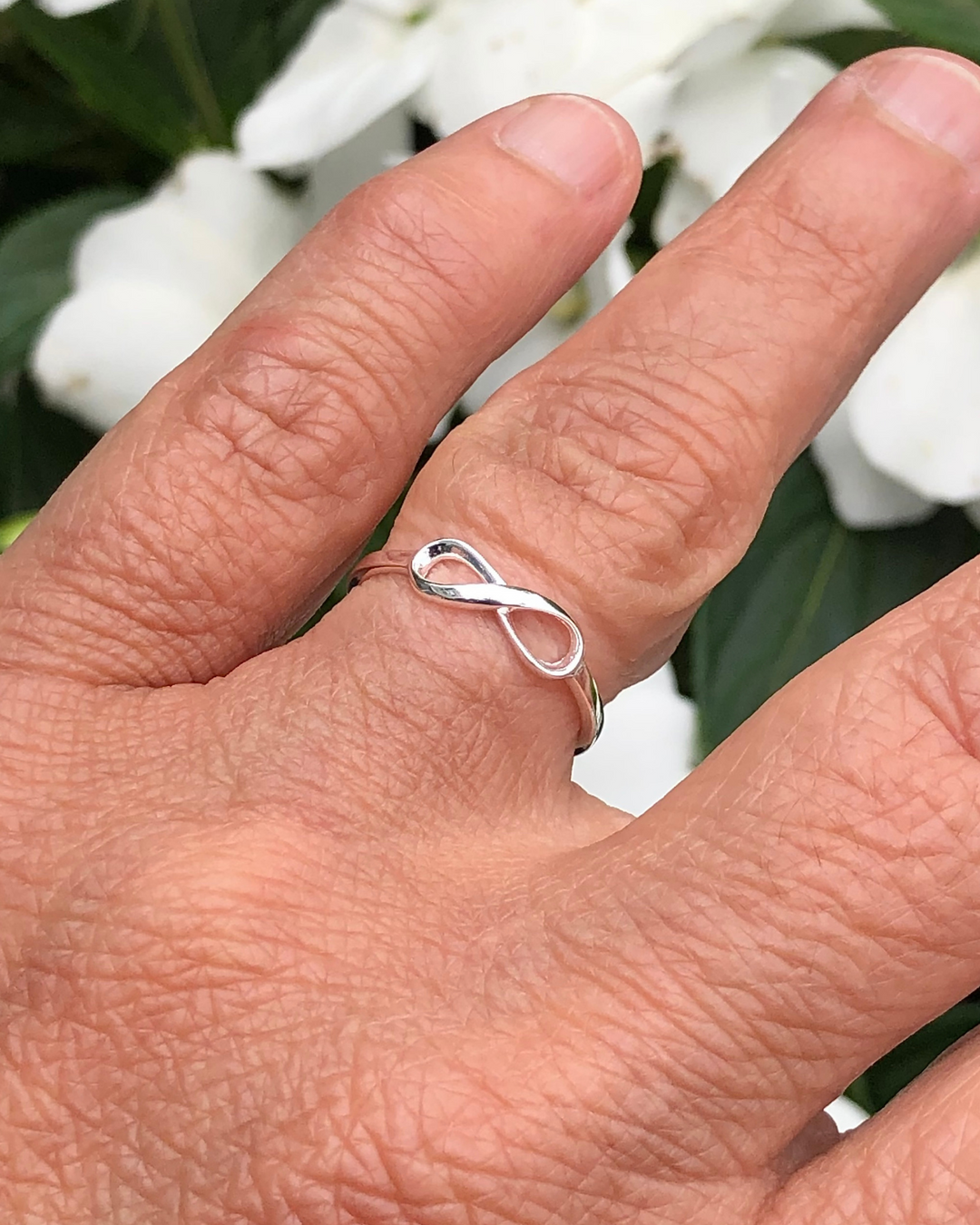 Silver Infinity Ring on ring finger