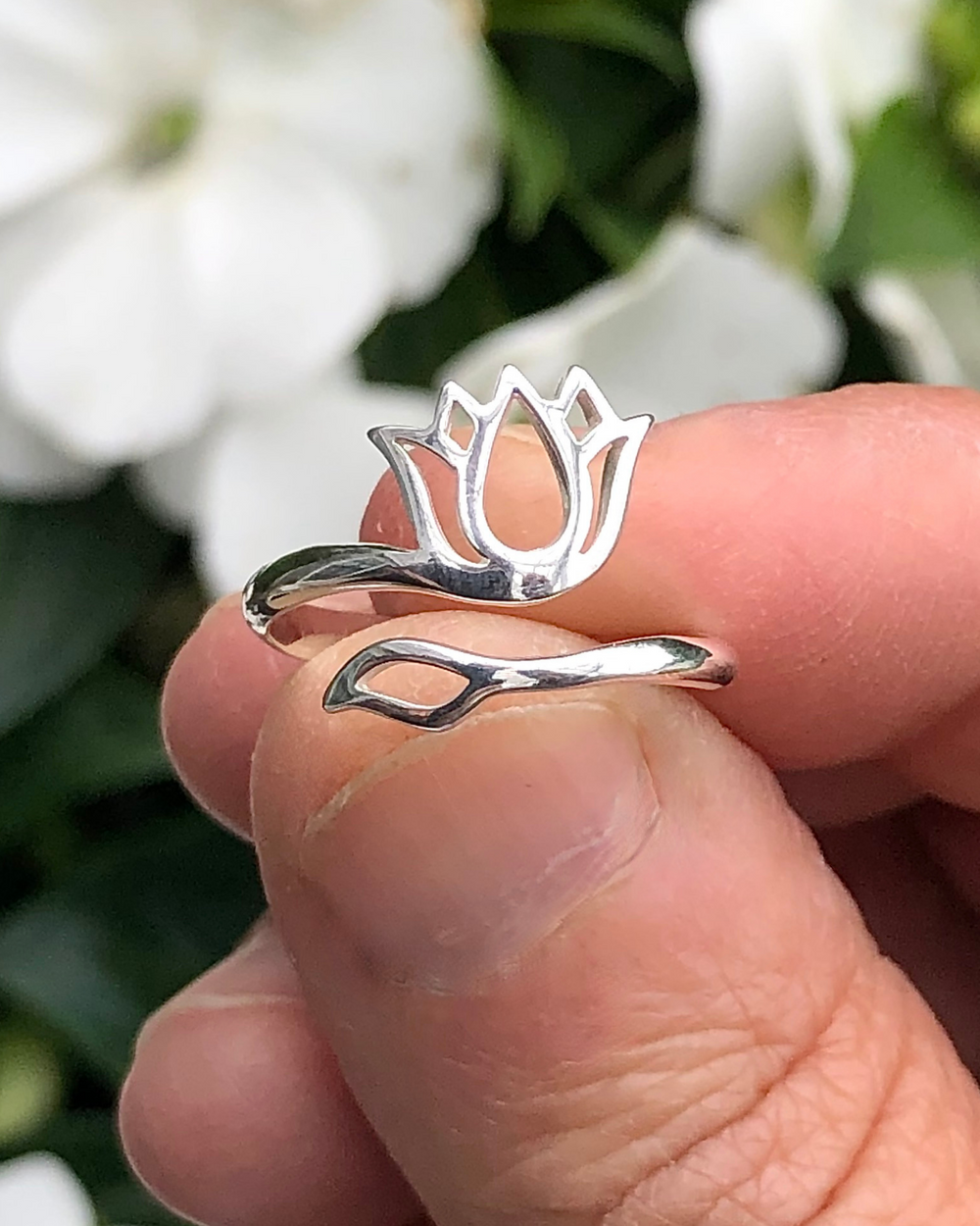 Sterling Silver Adjustable Lotus Ring between fingers