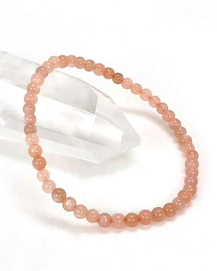 Sunstone 4mm Beaded Gemstone Bracelet on a crystal