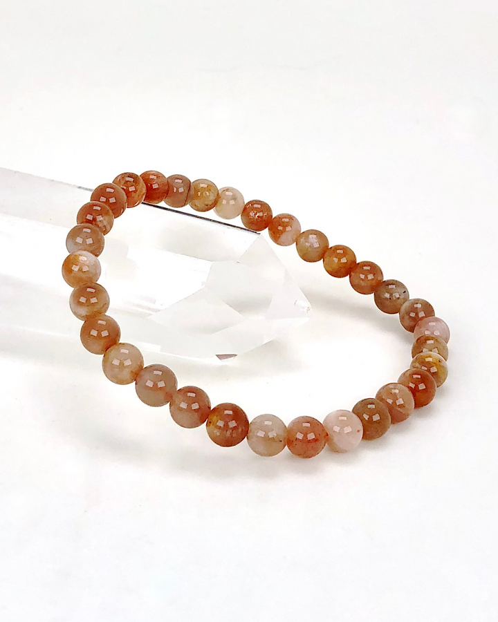 Sunstone 6mm Beaded Gemstone Bracelet on a crystal